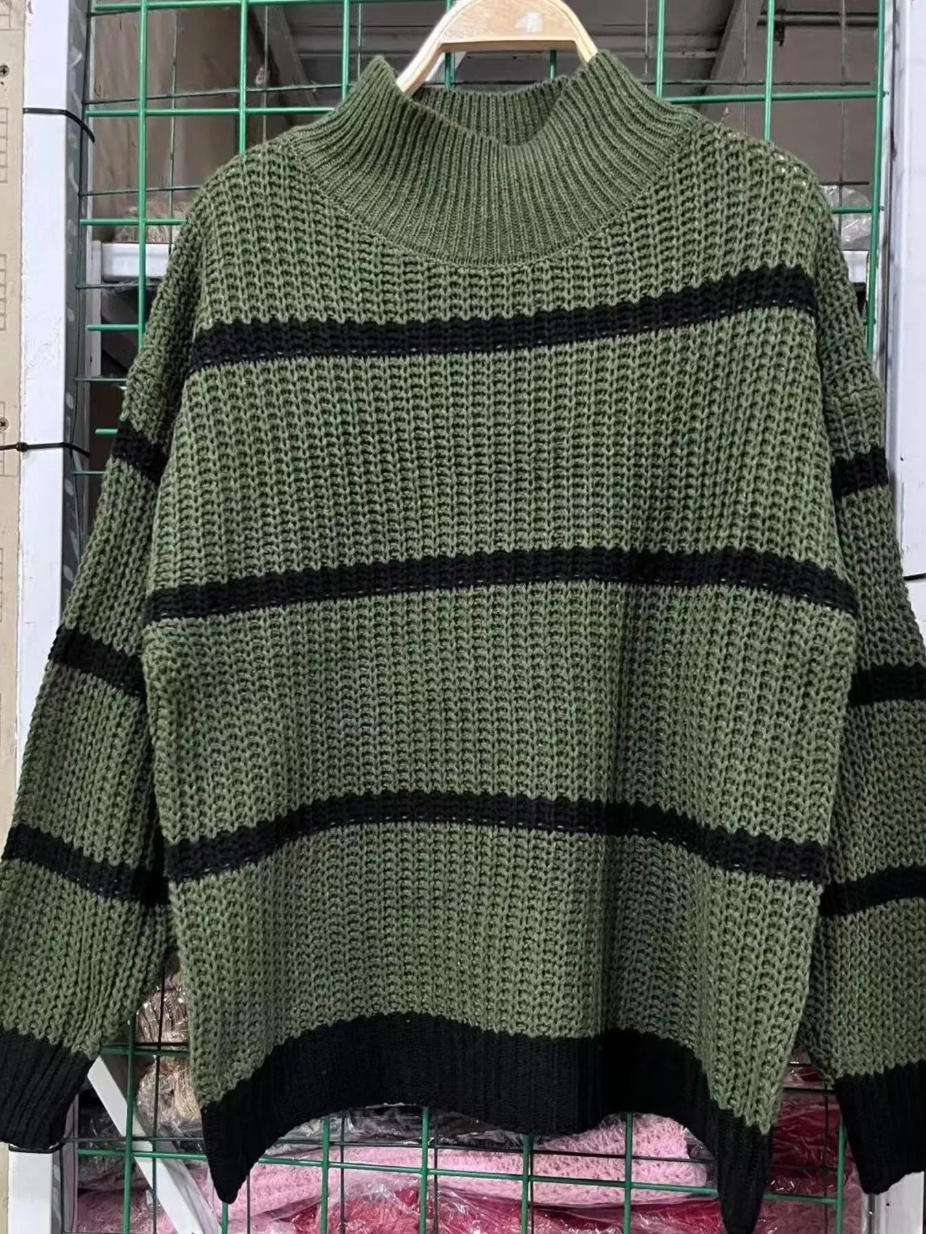 Elegant plus size sweater featuring a stylish striped pattern, perfect for sophisticated and comfortable fashion.