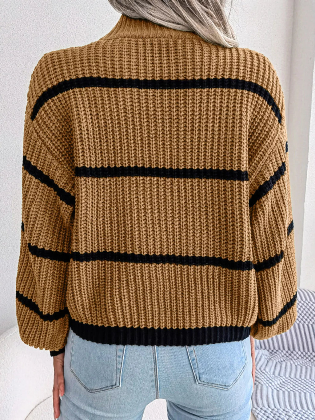 Elegant plus size sweater featuring a stylish striped pattern, perfect for sophisticated and comfortable fashion.