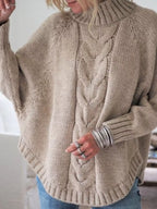Cable-knit plus size sweater showcasing comfortable and stylish knitwear for all body types