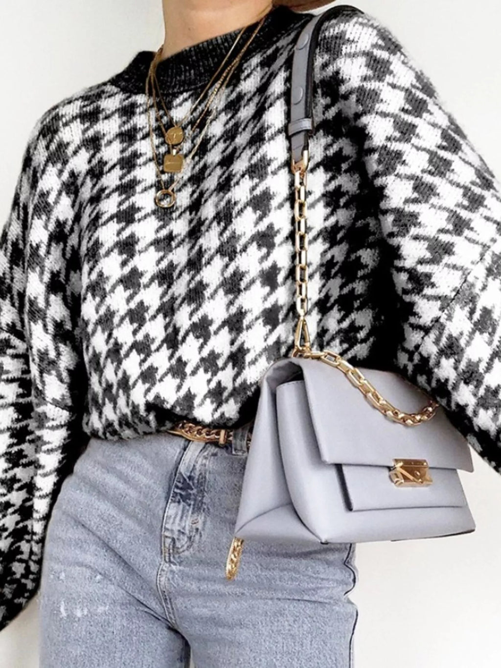 Plus size oversized sweater featuring a classic houndstooth pattern, perfect for stylish comfort.