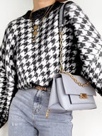 Plus size oversized sweater featuring a classic houndstooth pattern, perfect for stylish comfort.