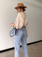 Plus size oversized sweater featuring a classic houndstooth pattern, perfect for stylish comfort.