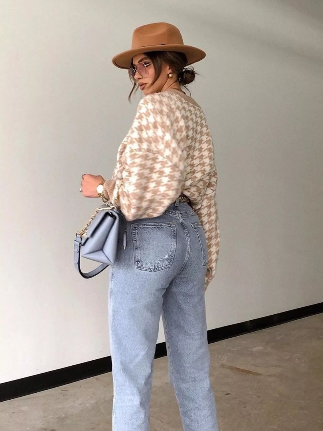 Plus size oversized sweater featuring a classic houndstooth pattern, perfect for stylish comfort.