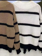 Elegant plus size sweater featuring a stylish striped pattern, perfect for sophisticated and comfortable fashion.