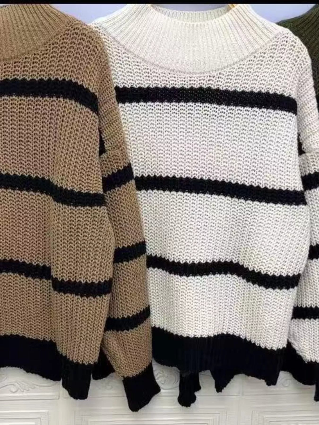 Elegant plus size sweater featuring a stylish striped pattern, perfect for sophisticated and comfortable fashion.