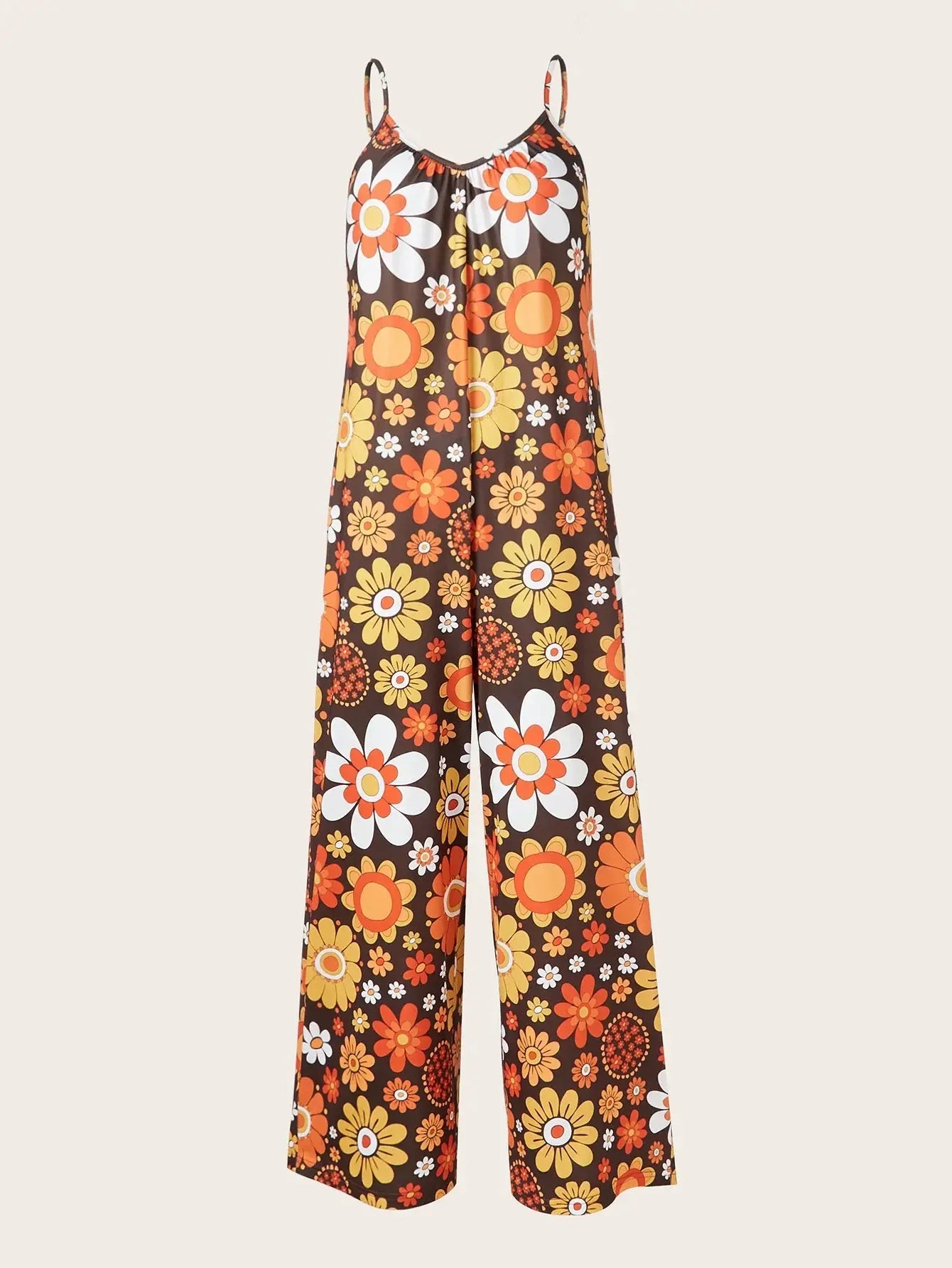 Woman wearing a loose floral print jumpsuit with thin straps.