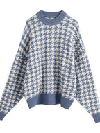 Plus size oversized sweater featuring a classic houndstooth pattern, perfect for stylish comfort.