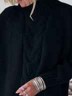 Cable-knit plus size sweater showcasing comfortable and stylish knitwear for all body types