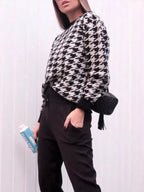 Plus size oversized sweater featuring a classic houndstooth pattern, perfect for stylish comfort.