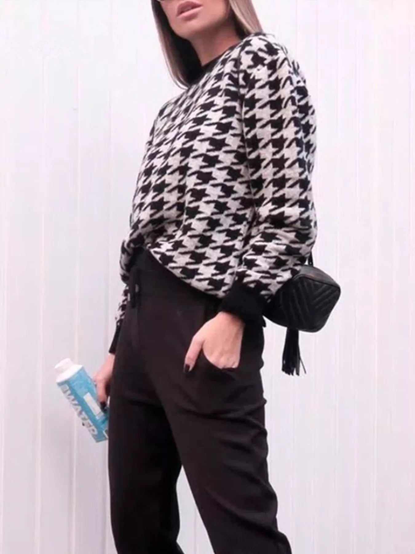 Plus size oversized sweater featuring a classic houndstooth pattern, perfect for stylish comfort.