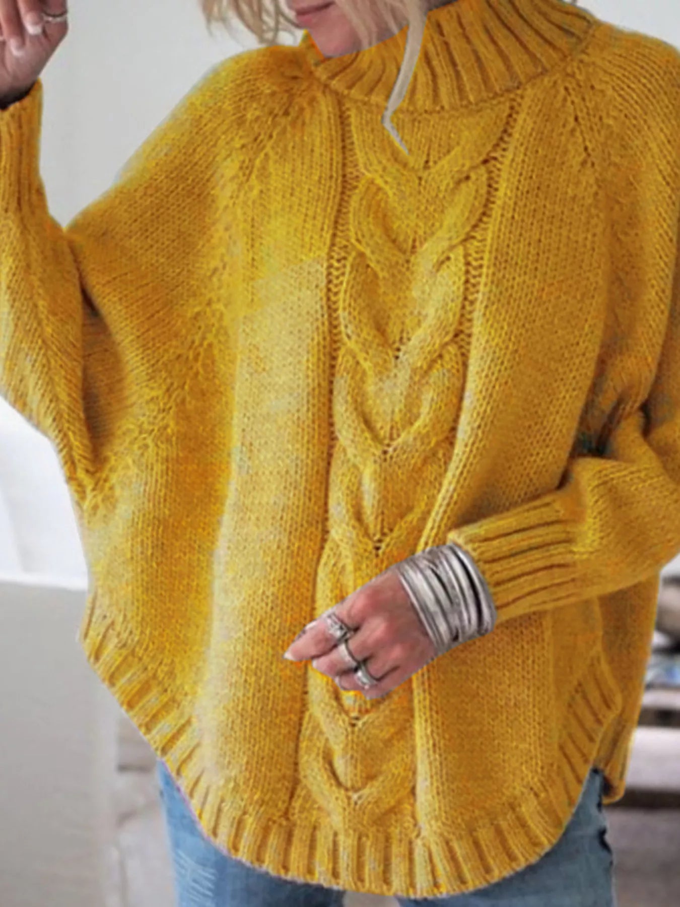 Cable-knit plus size sweater showcasing comfortable and stylish knitwear for all body types