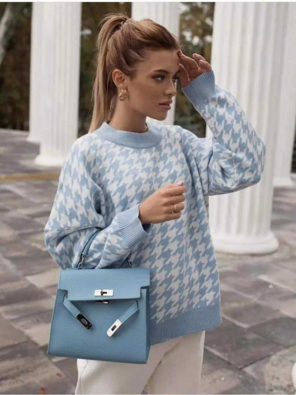 Plus size oversized sweater featuring a classic houndstooth pattern, perfect for stylish comfort.