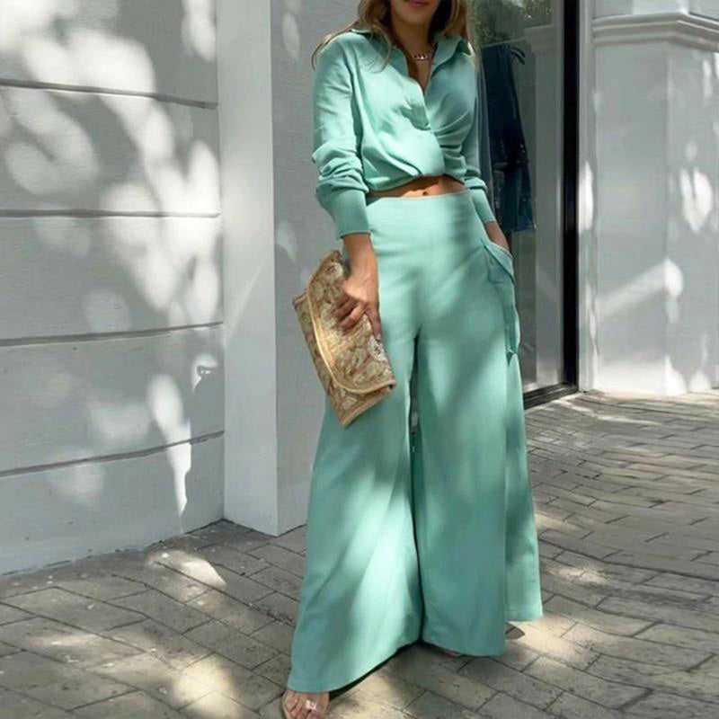 Womens plus size pant set featuring a chic crisscross top and flowy wide-leg pants in mint green with pockets.