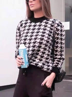 Plus size oversized sweater featuring a classic houndstooth pattern, perfect for stylish comfort.