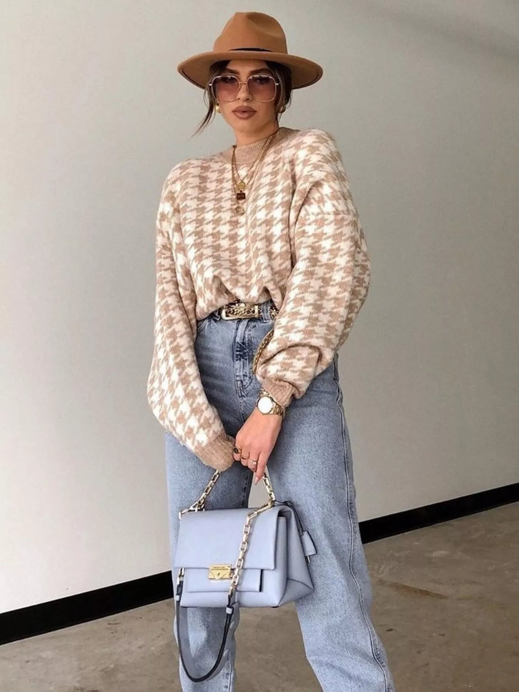 Plus size oversized sweater featuring a classic houndstooth pattern, perfect for stylish comfort.