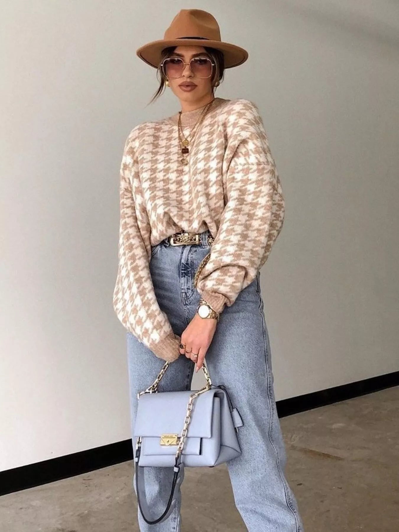 Plus size oversized sweater featuring a classic houndstooth pattern, perfect for stylish comfort.