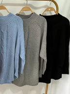 Cable-knit plus size sweater showcasing comfortable and stylish knitwear for all body types