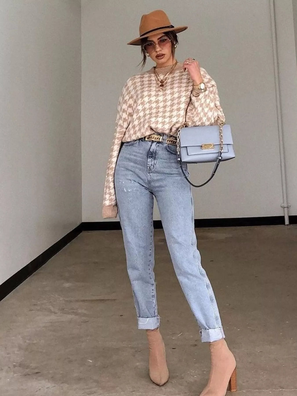 Plus size oversized sweater featuring a classic houndstooth pattern, perfect for stylish comfort.