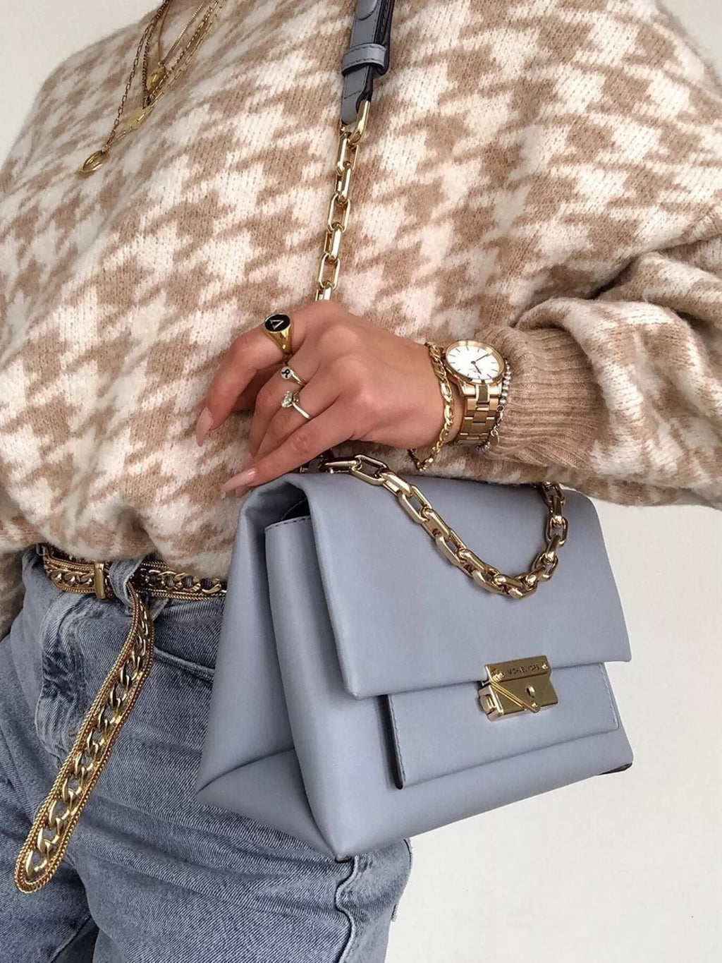 Plus size oversized sweater featuring a classic houndstooth pattern, perfect for stylish comfort.