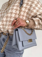 Plus size oversized sweater featuring a classic houndstooth pattern, perfect for stylish comfort.