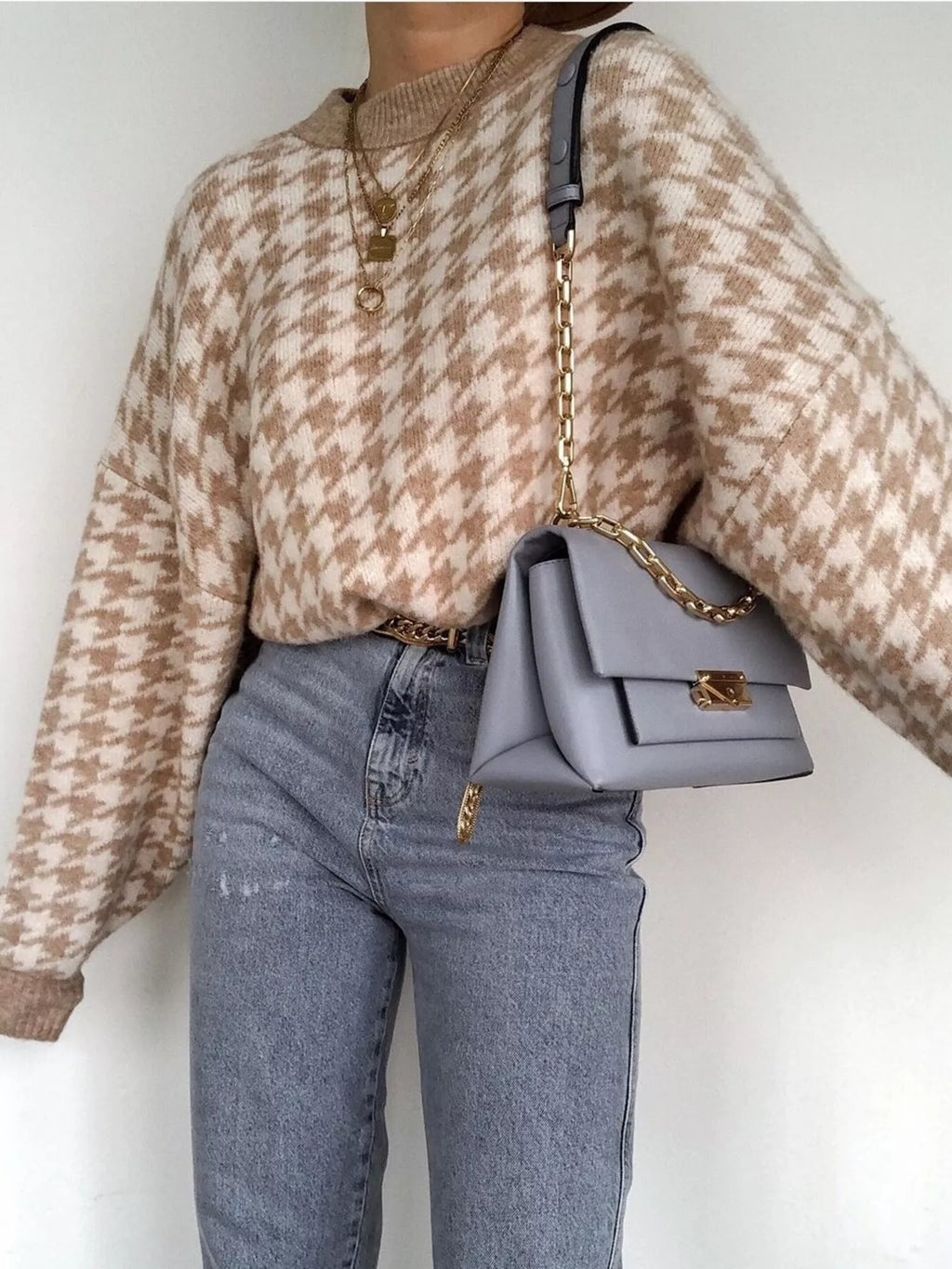 Plus size oversized sweater featuring a classic houndstooth pattern, perfect for stylish comfort.