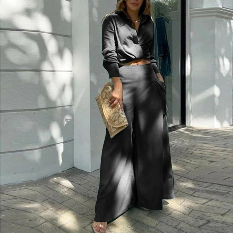 Womens plus size pant set featuring a crisscross top and wide-leg pants in black, styled for elegance and comfort.