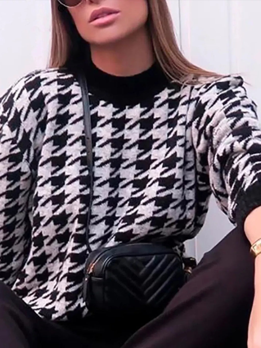 Plus size oversized sweater featuring a classic houndstooth pattern, perfect for stylish comfort.