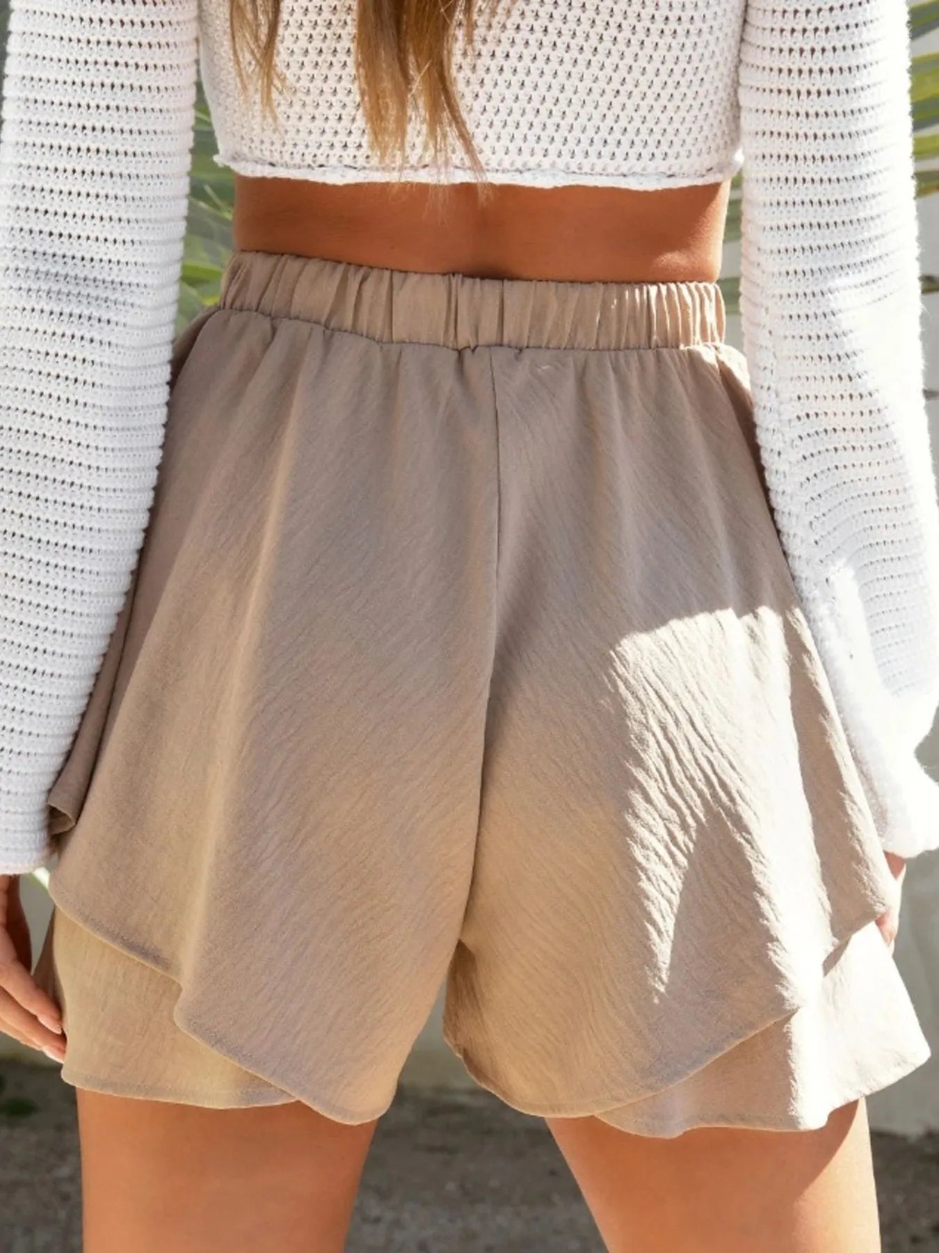 Elegant high-waisted layered shorts showcasing trendy summer fashion and comfortable style for women