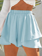 Elegant high-waisted layered shorts showcasing trendy summer fashion and comfortable style for women