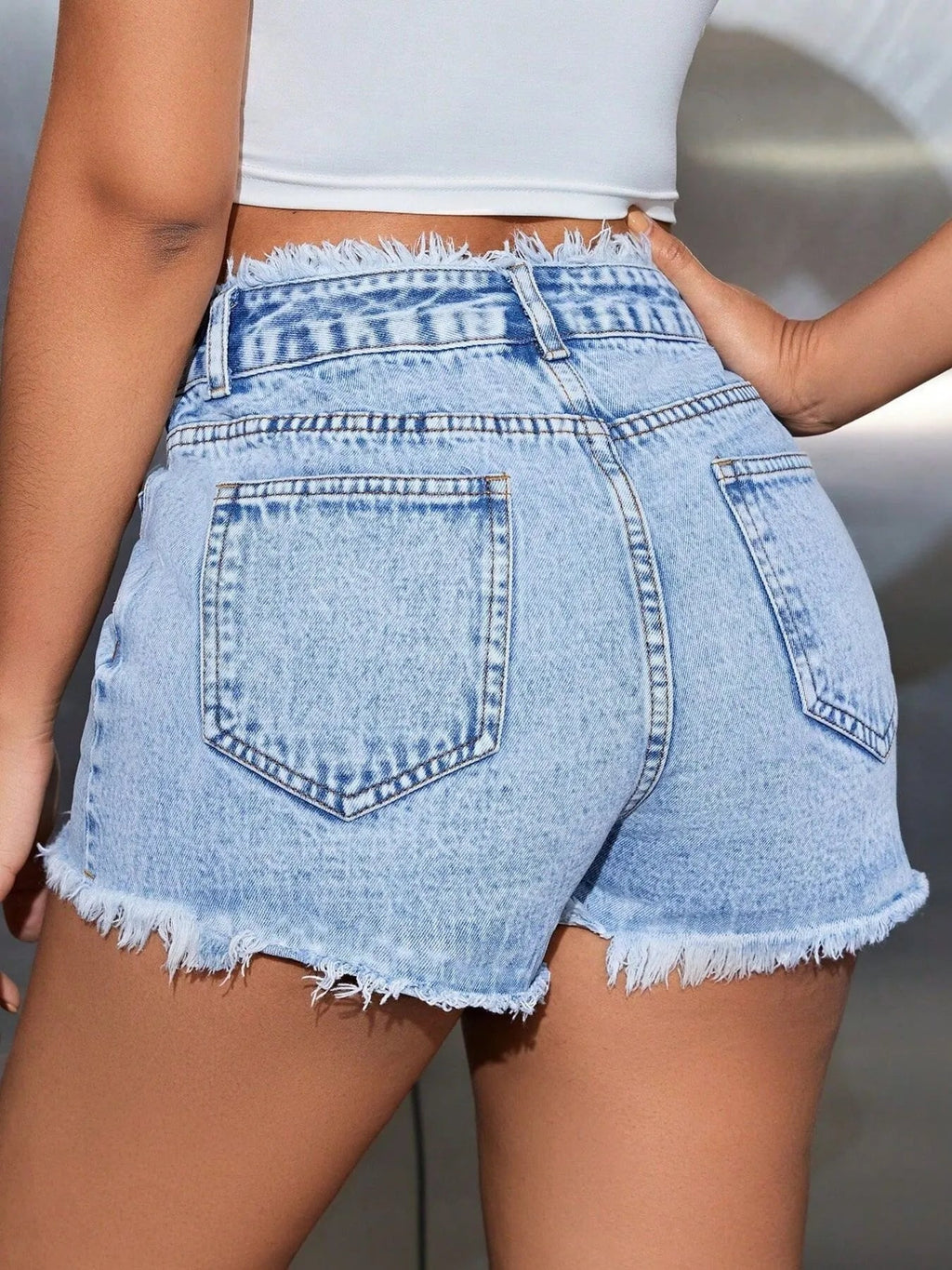 High waisted denim shorts providing a stylish and comfortable summer wardrobe essential for casual outings.
