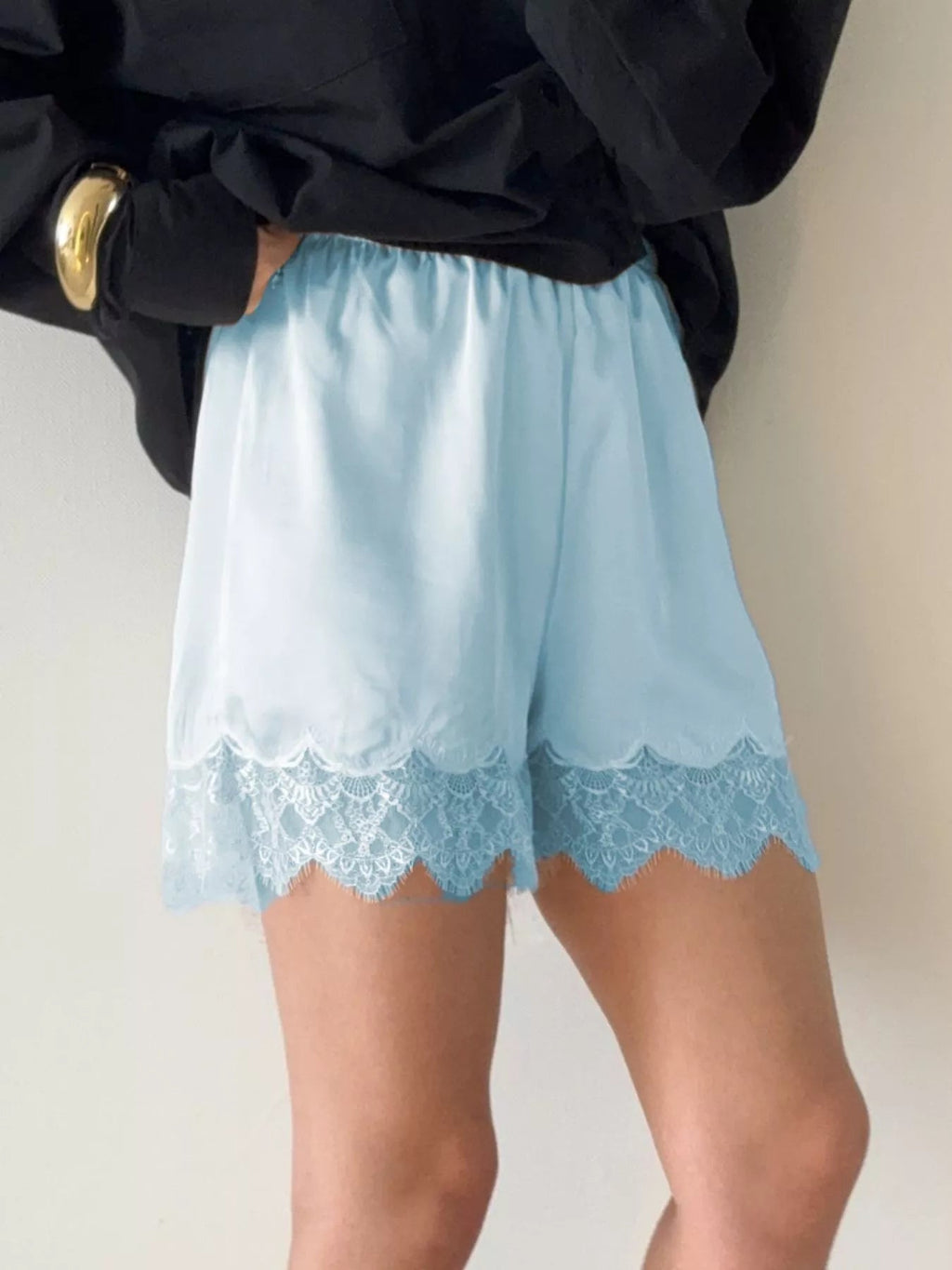 Elegant lace shorts showcasing intricate design and refined craftsmanship for sophisticated summer fashion.