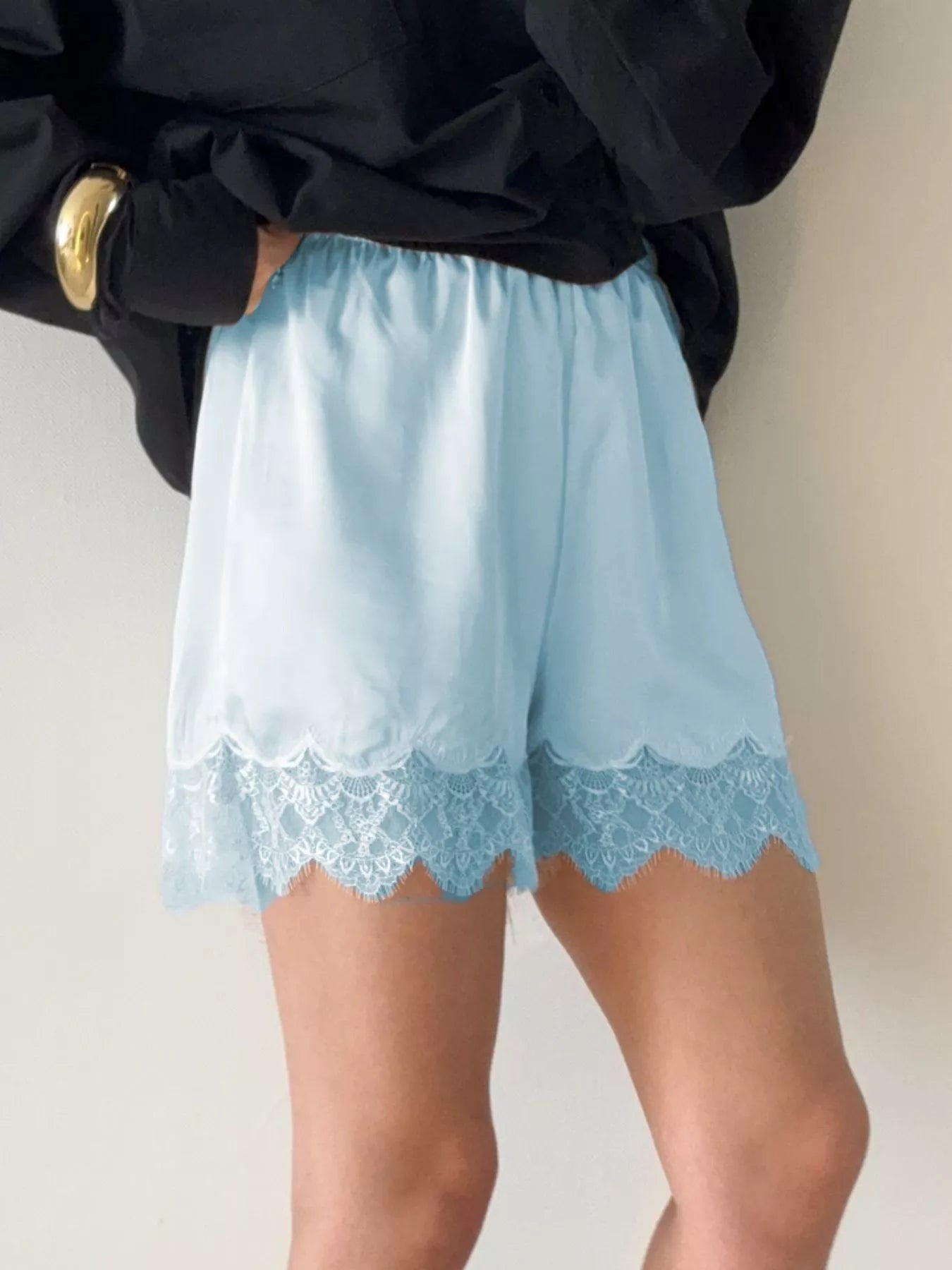 Elegant lace shorts showcasing intricate design and refined craftsmanship for sophisticated summer fashion.