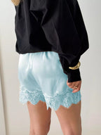 Elegant lace shorts showcasing intricate design and refined craftsmanship for sophisticated summer fashion.