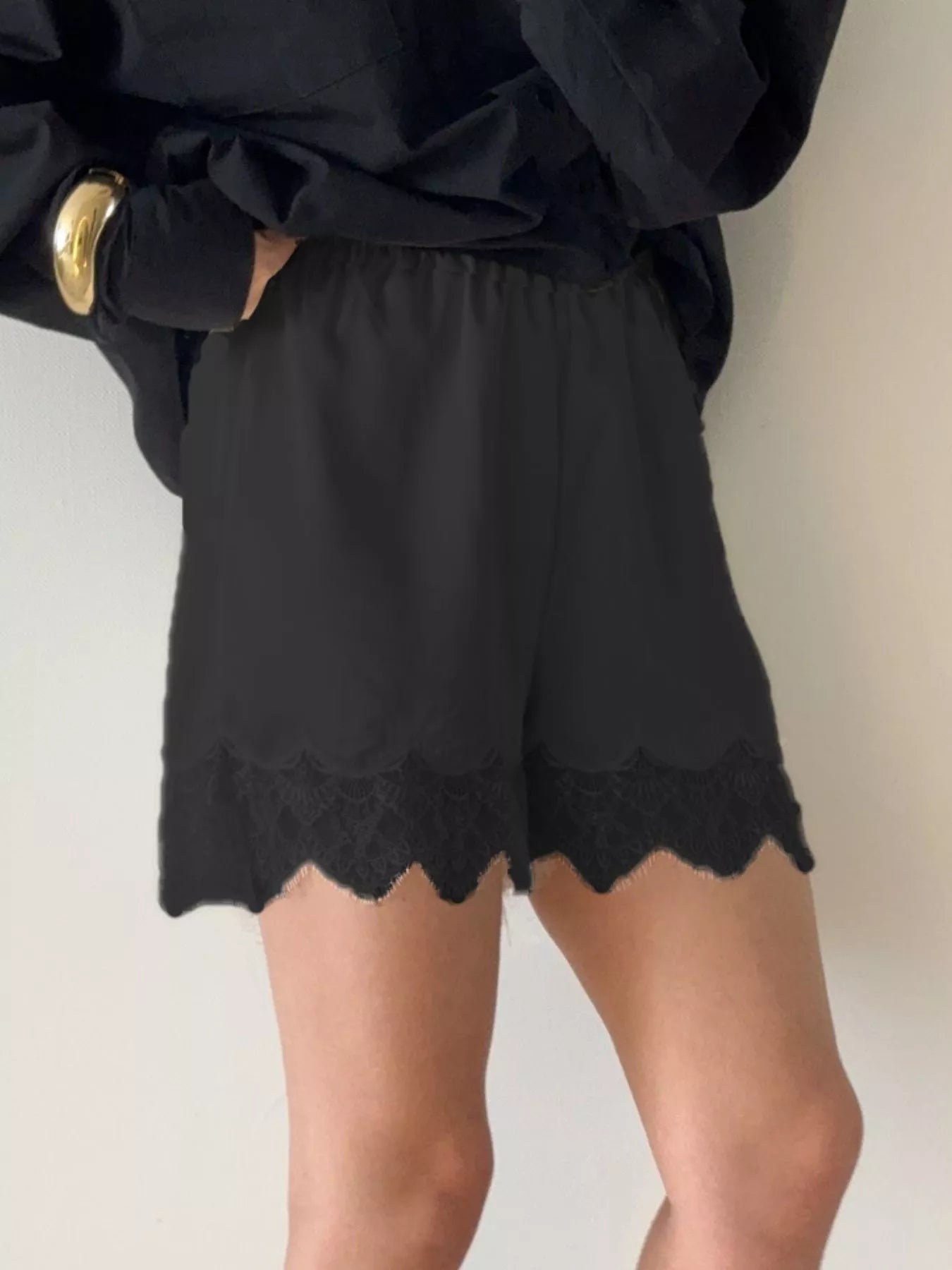 Elegant lace shorts showcasing intricate design and refined craftsmanship for sophisticated summer fashion.