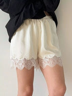 Elegant lace shorts showcasing intricate design and refined craftsmanship for sophisticated summer fashion.