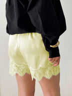 Elegant lace shorts showcasing intricate design and refined craftsmanship for sophisticated summer fashion.
