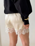 Elegant lace shorts showcasing intricate design and refined craftsmanship for sophisticated summer fashion.