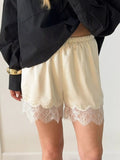 Elegant lace shorts showcasing intricate design and refined craftsmanship for sophisticated summer fashion.