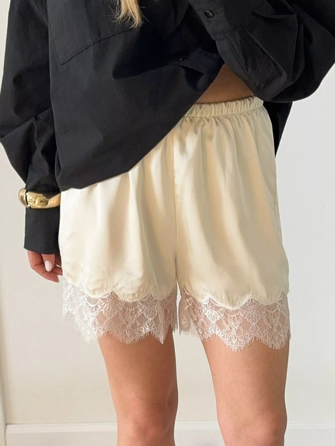 Elegant lace shorts showcasing intricate design and refined craftsmanship for sophisticated summer fashion.
