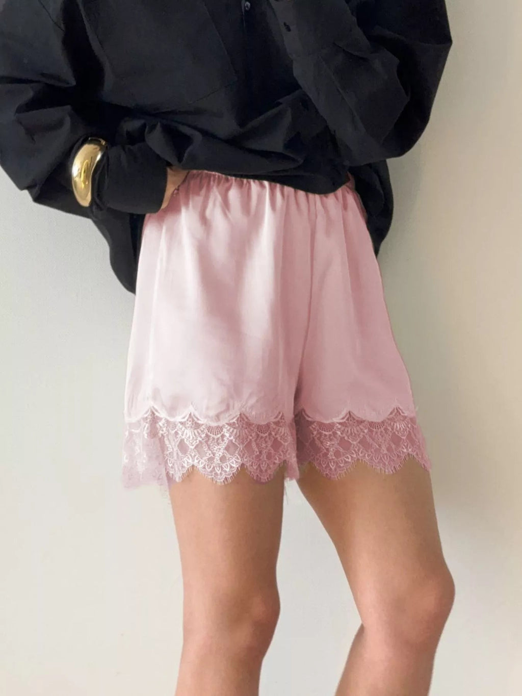 Elegant lace shorts showcasing intricate design and refined craftsmanship for sophisticated summer fashion.
