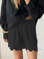 Elegant lace shorts showcasing intricate design and refined craftsmanship for sophisticated summer fashion.