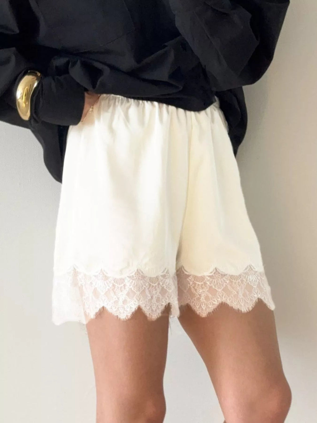 Elegant lace shorts showcasing intricate design and refined craftsmanship for sophisticated summer fashion.