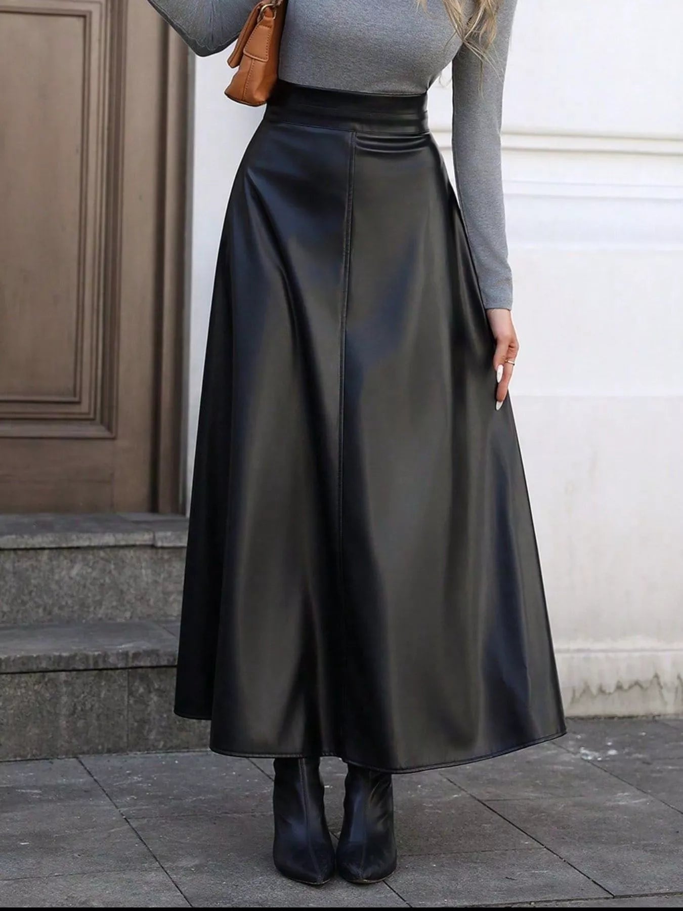 Elegant leather skirt showcasing premium craftsmanship, perfect for formal occasions and stylish wardrobes.