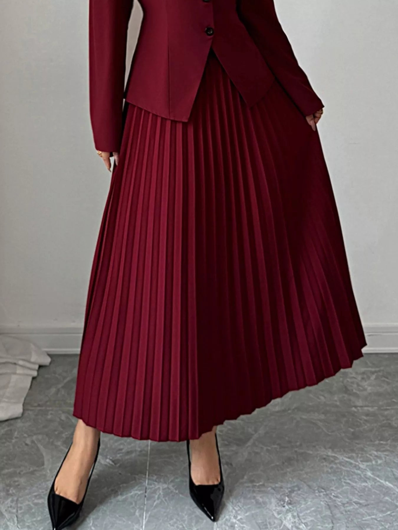 Elegant pleated midi skirt showcasing classic skirt design perfect for formal occasions and stylish outfits.