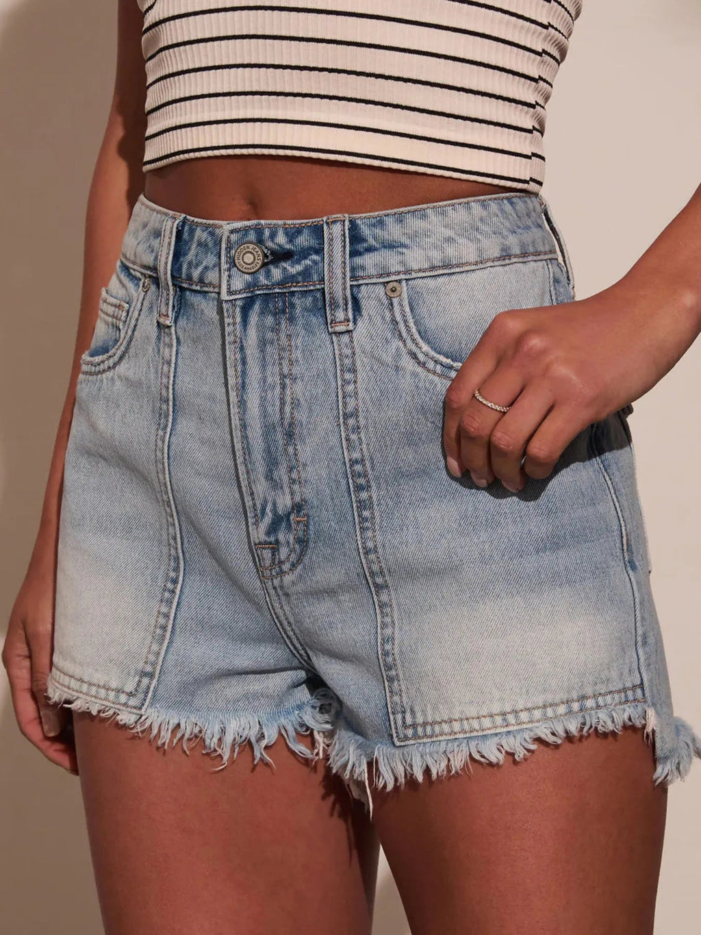 Stylish denim shorts with raw hem detailing for a trendy and casual summer look
