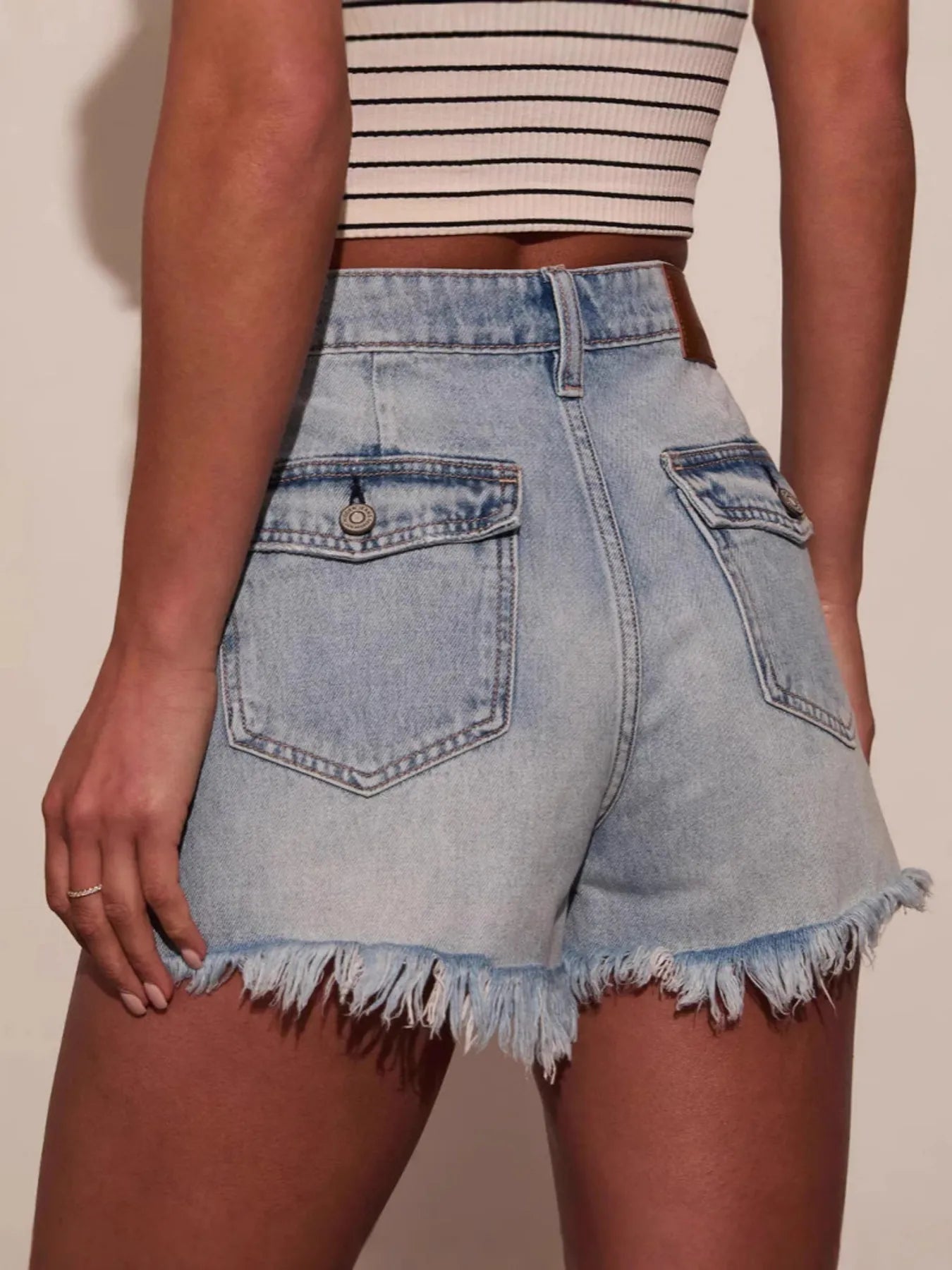 Stylish denim shorts with raw hem detailing for a trendy and casual summer look