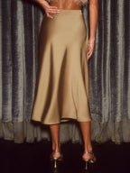Elegant satin midi skirt showcasing smooth texture and versatile style in fashionable women's wardrobe