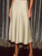 Elegant satin midi skirt showcasing smooth texture and versatile style in fashionable women's wardrobe