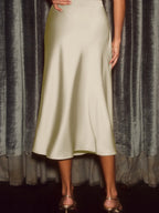 Elegant satin midi skirt showcasing smooth texture and versatile style in fashionable women's wardrobe