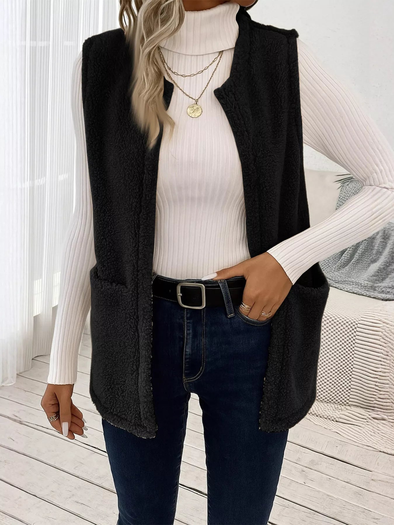 Warm sleeveless fleece vest ideal for layering, offering comfort and versatility in cold weather.